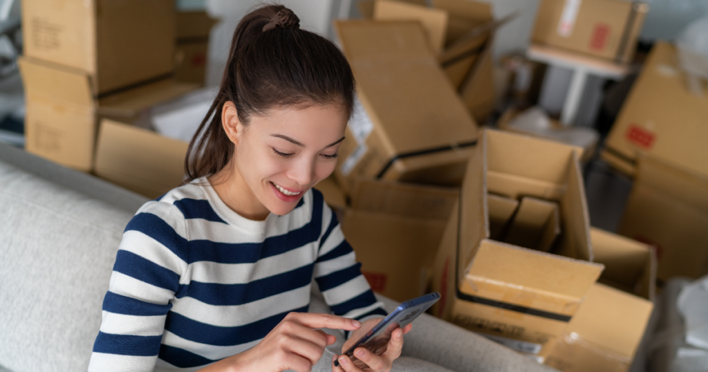 woman on phone in a room full of boxes